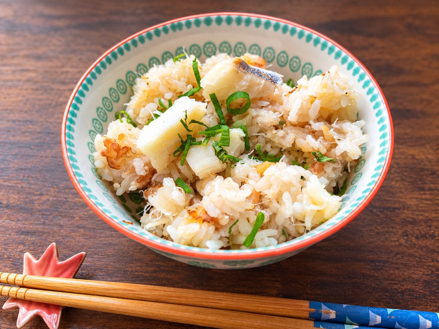 Cod takikomi rice topped with green onion and white sesame seeds