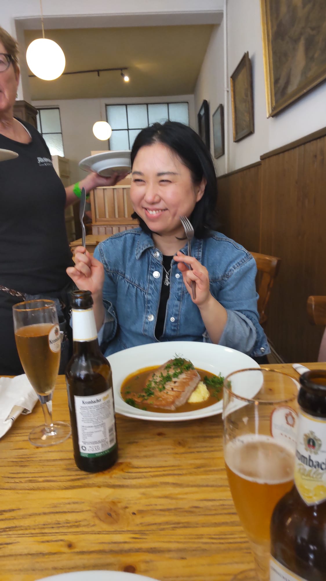 Hiroko smiling at a restaurant table
