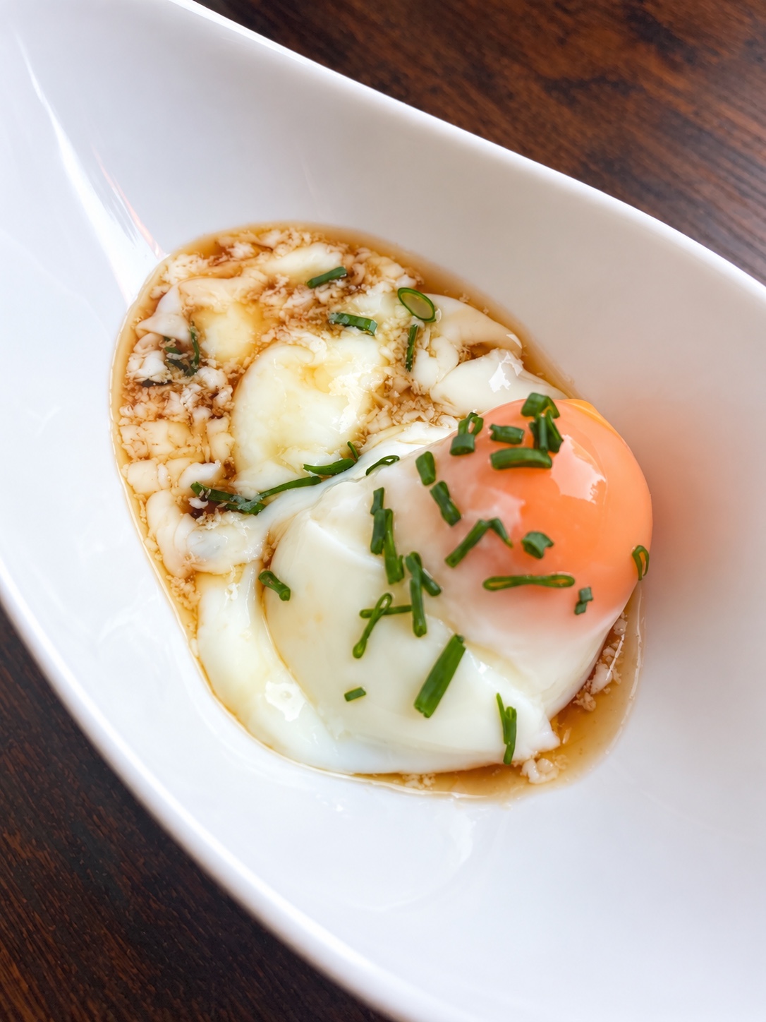 Onsen egg with soft white and a rich yolk, served with soy sauce