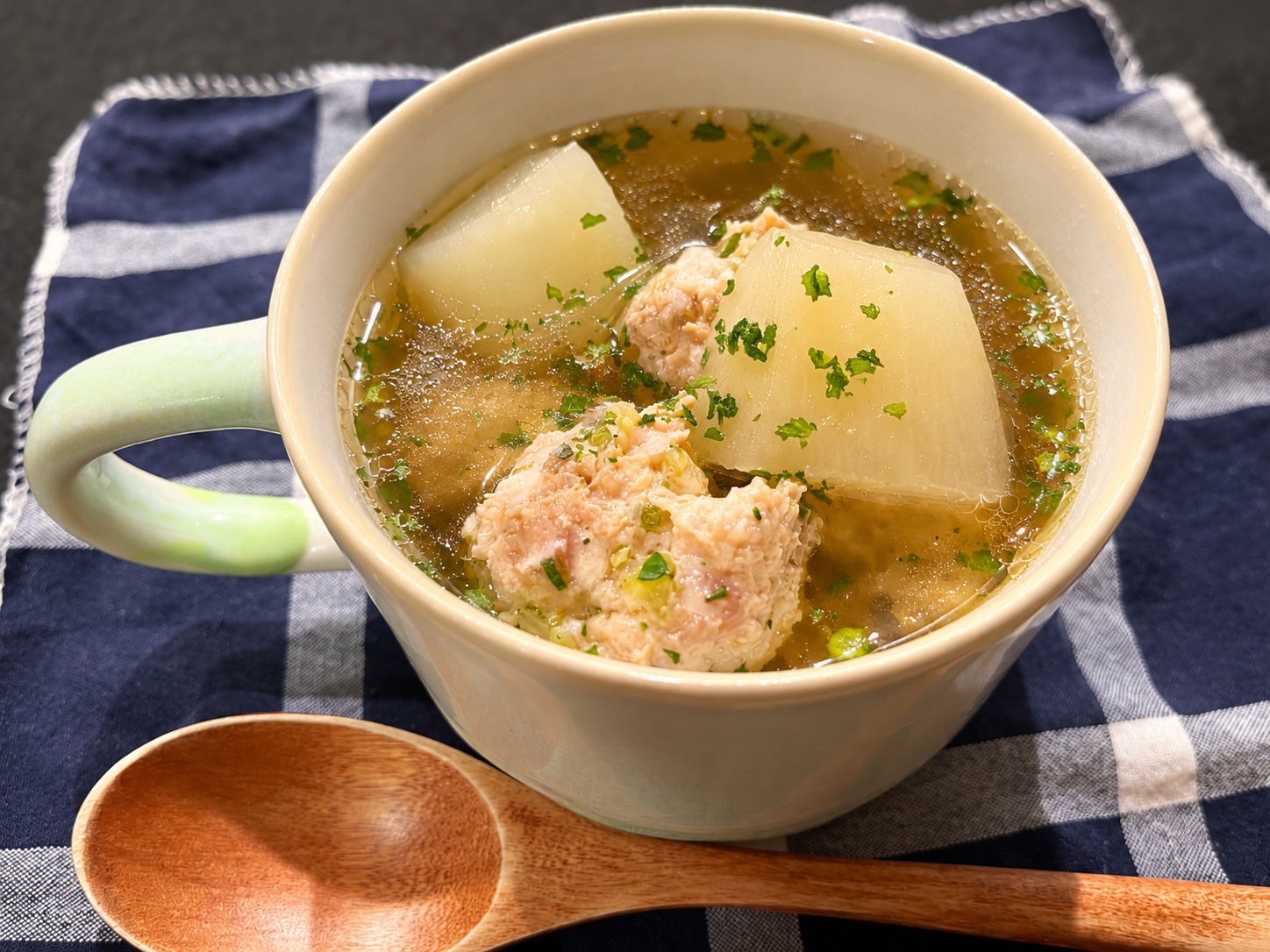White radish and chicken meatballs in a golden broth